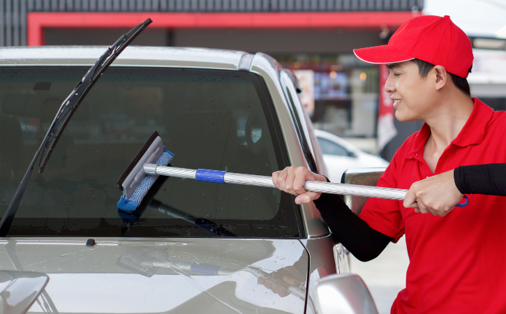 Cleaning Windshield with Squeege